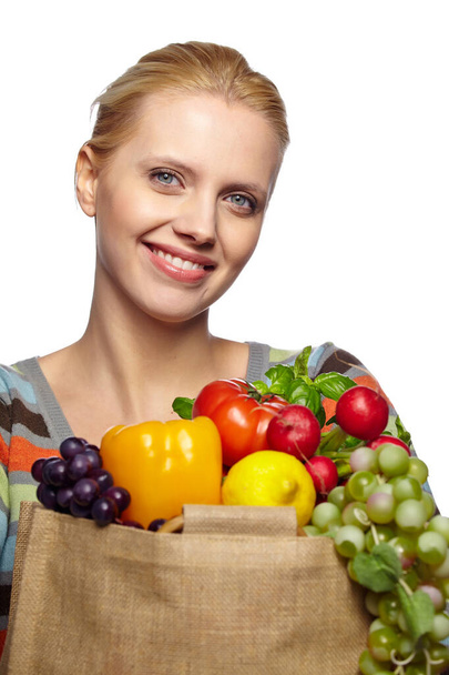 woman holding grocery paper shopping bag full of fresh vegetables. Diet healthy eating concept isolated on a white background - 写真・画像