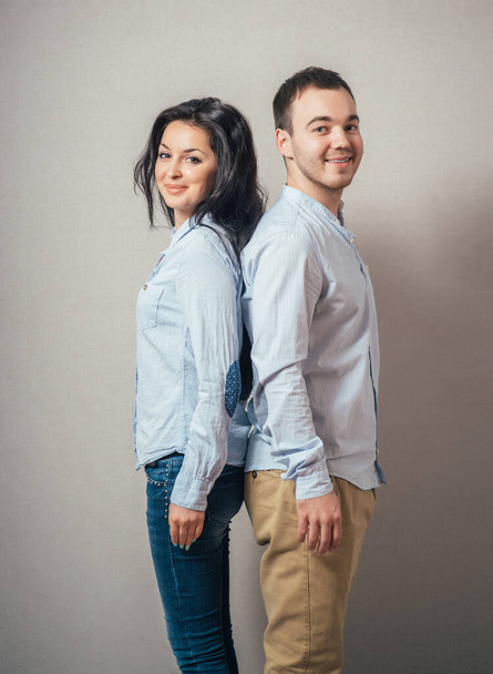 Lovely young couple  back to back. - Foto, Bild