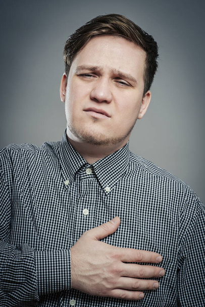 A young man suffering from heart pain - Fotó, kép