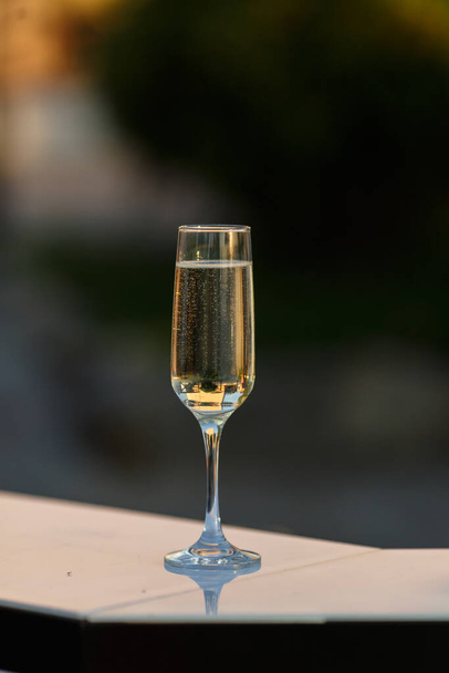 One glass of champagne on a blurred background - Φωτογραφία, εικόνα