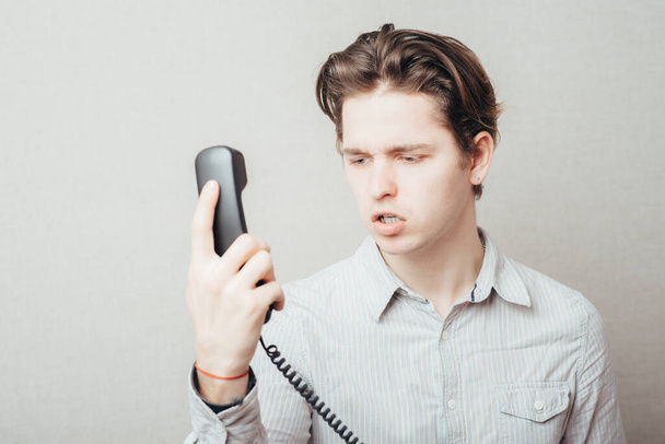 portrait of young man talking on a vintage telephone  - Foto, immagini