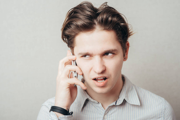 Portrait of young pensive businessman talking on cell phone - Φωτογραφία, εικόνα