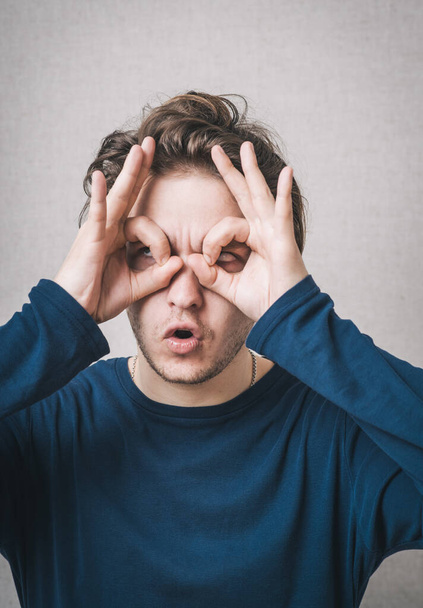 hombre hace binoculares manos
 - Foto, imagen