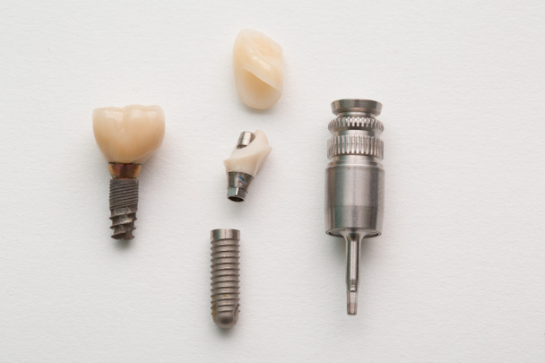 Dental implant of a human tooth and its parts on a white background - Photo, Image