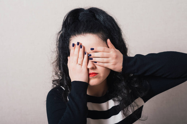 girl covering her eyes with her hands - Valokuva, kuva