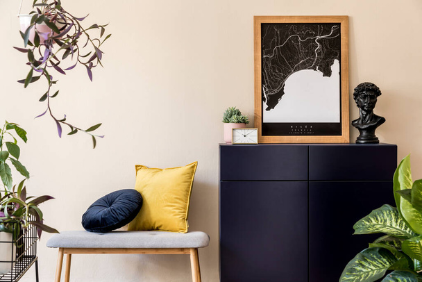 Interior design of sitting room with stylish wooden bench, gold clock, plants, commode and elegant personal accessoreis. Brown wooden mock up poster map on the beige wall. Home decor. Template. - Photo, image