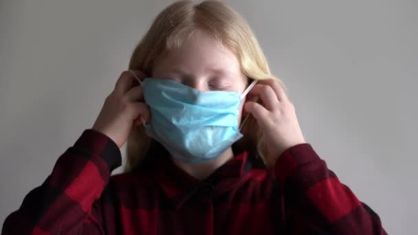 ochrana proti koronaviru. dívka si nasadí masku na obličej. - Záběry, video