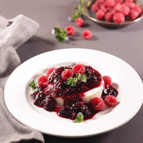 panna cotta with berry fruit in plate - Фото, изображение