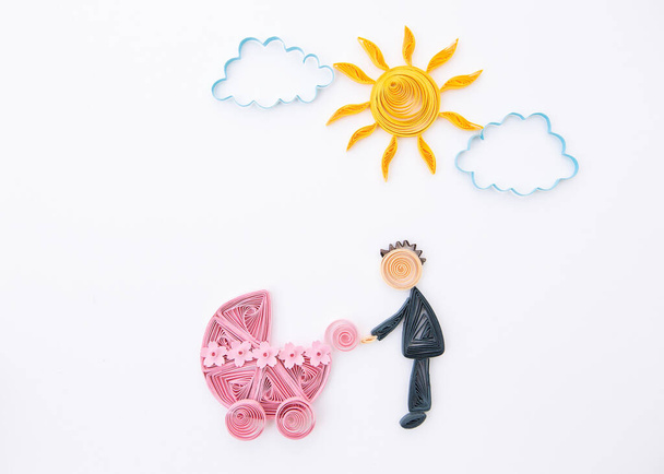 Father with a newborn baby. Parrent with carriage. Hand made of paper quilling technique. - Photo, Image