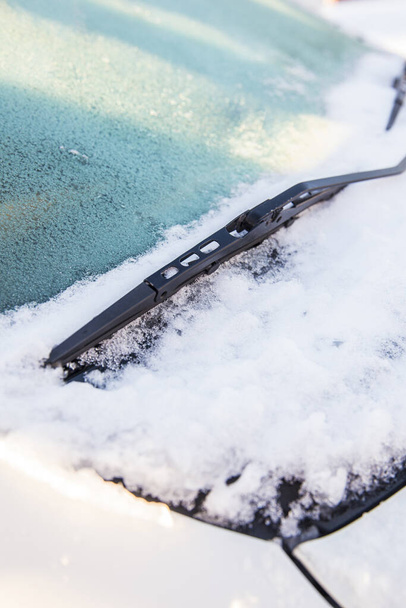 Close up widok wycieraczki samochodowe lub wycieraczki wiedźma są zamrożone i tkwi w śniegu i lodzie na zewnątrz w zimie. - Zdjęcie, obraz