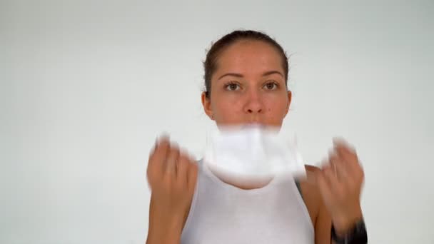 Young Woman wears protective mask on white wall background - Filmmaterial, Video