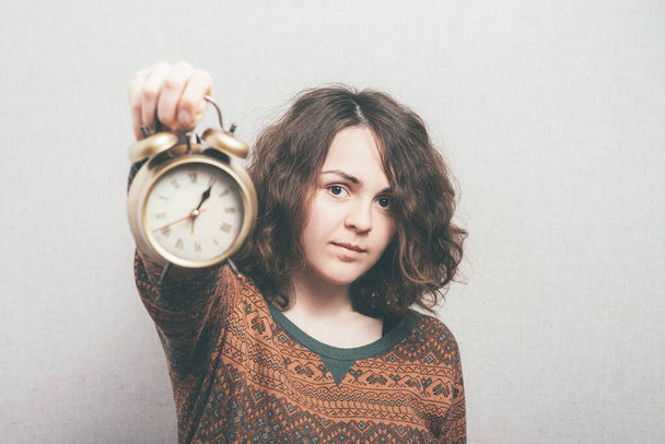 girl with an alarm clock - Фото, изображение