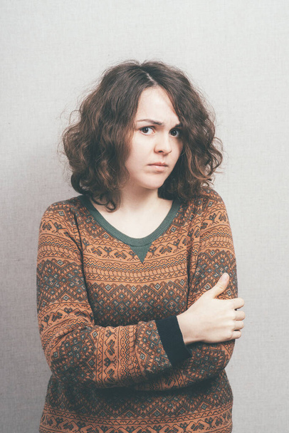Girl, hands clasped against studio background - Fotografie, Obrázek