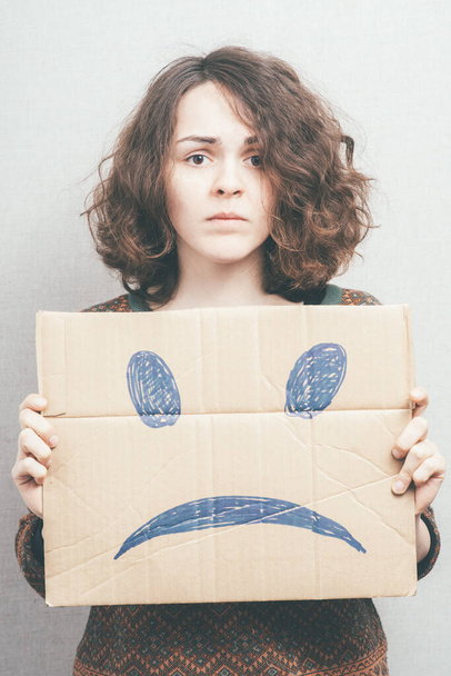Girl shows a sad smiley - Foto, Imagem