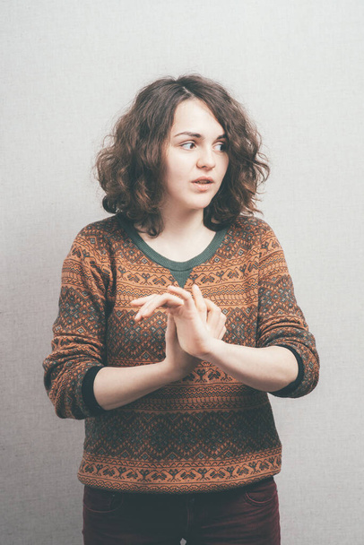 woman gesturing against studio background  - Foto, imagen