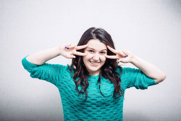 Happy smiling beautiful young woman showing two fingers or victory gesture - Fotografie, Obrázek