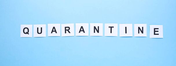 The word quarantine written on a blue hospital background. Concept of quarantine and isolation. Long format for web - Foto, Imagen
