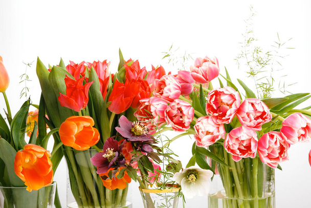 Яркие букеты тюльпанов, праздничная весенняя композиция на белом фоне - Фото, изображение