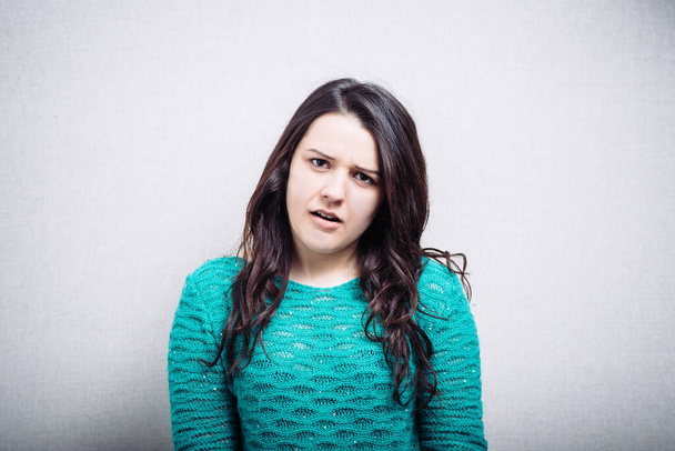 portrait of a cute brunette girl is offended - Photo, image