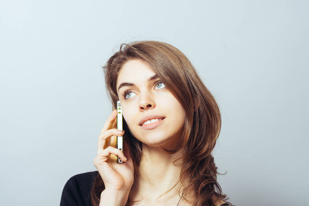 funny cute brunette girl talking on a cell phone - Foto, Imagen