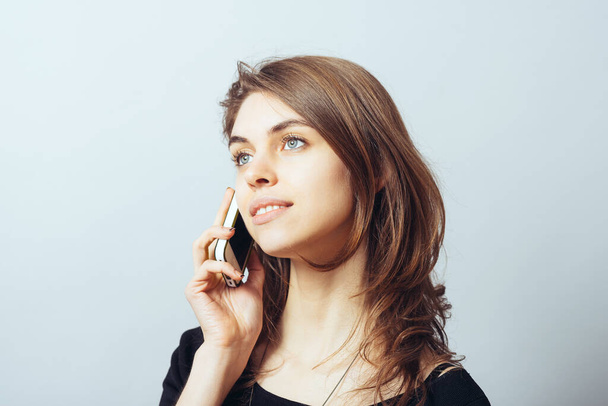 funny cute brunette girl talking on a cell phone - Foto, imagen