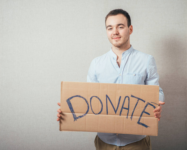 man holding Cardboard text a donate - Fotografie, Obrázek