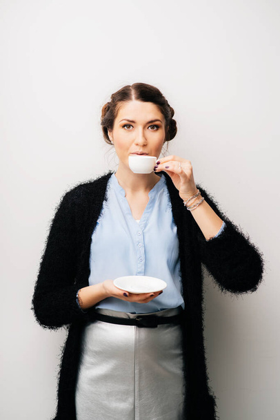 A woman with a small white cup, drink tea or coffee. Isolated on a white background - Valokuva, kuva