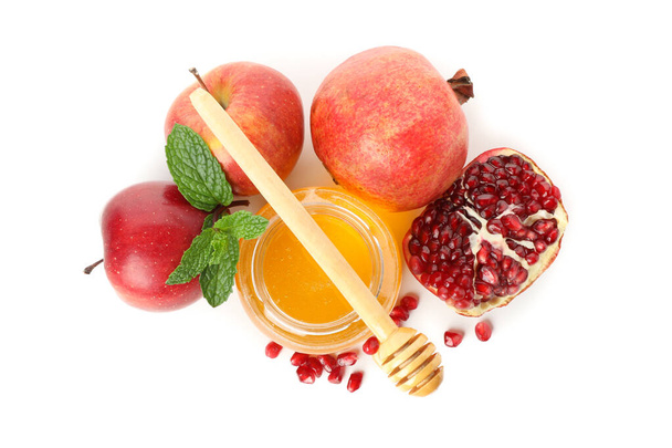 Omenat, granaattiomena ja hunaja eristetty valkoisella pohjalla. Luonnon käsittely
 - Valokuva, kuva