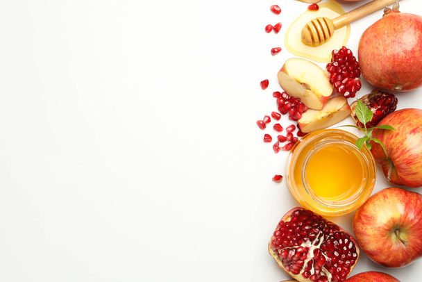Apple, pomegranate and honey on white background, top view. Home treatment - Photo, Image