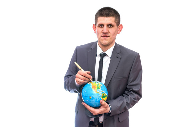 Man in suit pointing with pen on globe - Фото, зображення