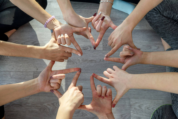 Circle of human hands doing yoga exercises close up - Photo, Image