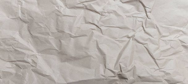 Texture of crumpled kraft or packing paper brown color. Wide-angle background for design works - Photo, Image