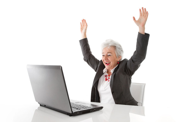 Happy mature woman with laptop - Foto, afbeelding