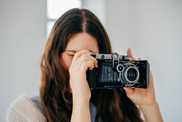 Close-up portrait of a  girl with a photocamera - Φωτογραφία, εικόνα