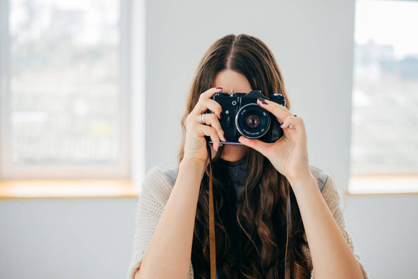 Close-up portrait of a  girl with a photocamera - Фото, зображення