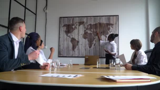 African american female business coach gives corporate presentation for businesspeople in office, dark skinned businessman presents new business plan, speaking to clients - Footage, Video