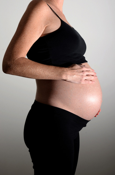expectant mother with hands on tummy - Valokuva, kuva