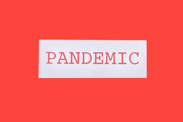 top view of pandemic lettering isolated on red  - 写真・画像