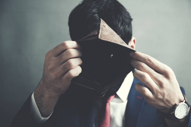 Business Person holding an empty wallet - Fotó, kép