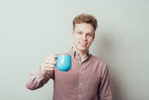 man with a cup - Фото, изображение