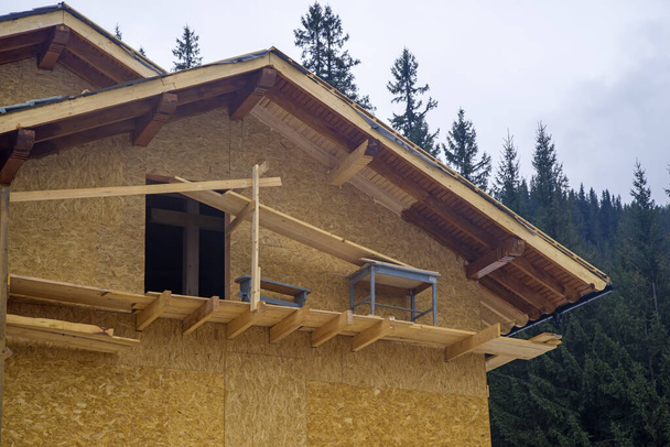 Wooden chalet construction in the forest, exterior works - Photo, Image