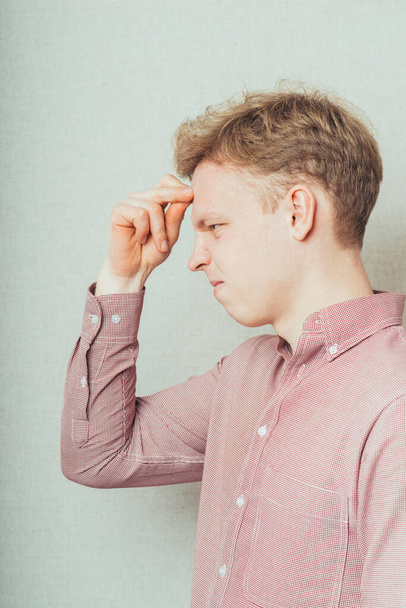 young man thinking with hand on face - Fotografie, Obrázek