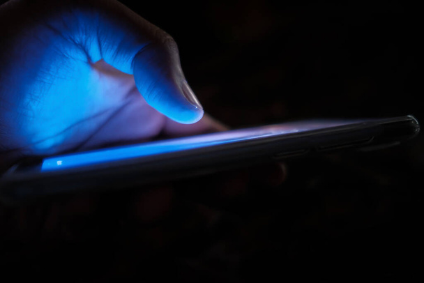 primer plano de la mano de la persona utilice el teléfono inteligente en la noche
  - Foto, imagen