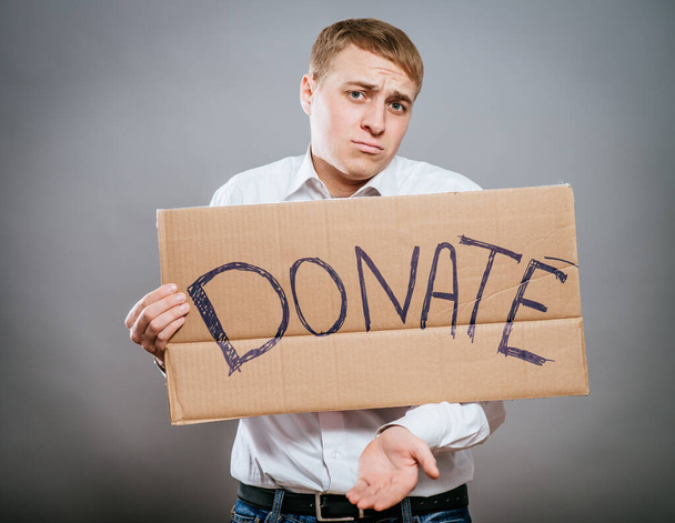 man holding Cardboard text a donate - Photo, image