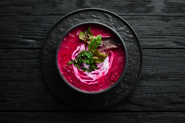 Red beet soup with sour cream. Ukrainian cuisine, Borsch soup. Top view. Free space for your text. Rustic style. - Zdjęcie, obraz