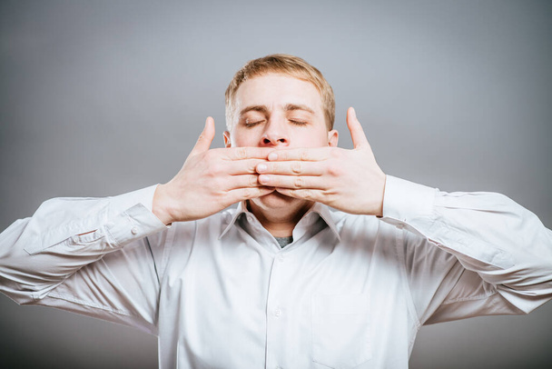 Speak no evil concept - Face of men covering his mouth. - Фото, зображення