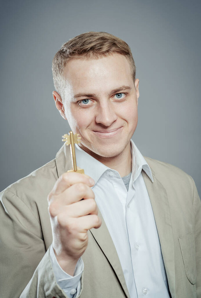 Man offering key to Your dream ... - Zdjęcie, obraz