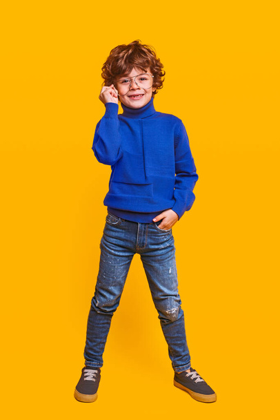 Positive stylish child adjusting glasses - Foto, Imagem