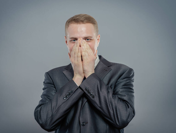 young businessman in shock with hands on face - Photo, Image