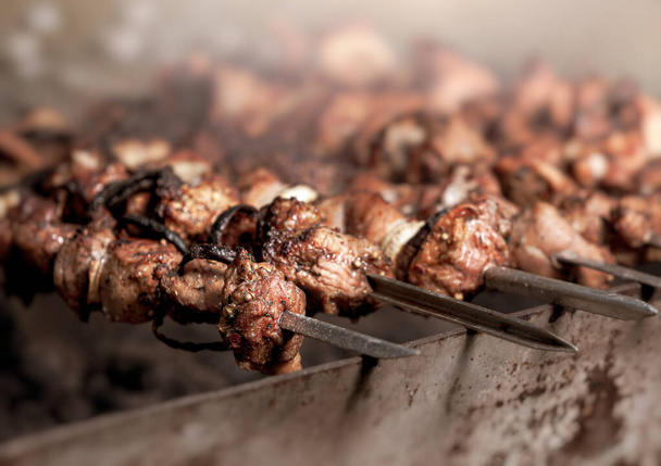 Shashlik cooking concept. Close-up of grilling tasty dish on barbecue. Grilling shashlik on barbecue grill - Photo, Image
